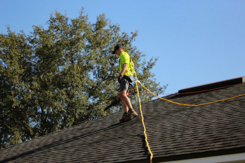 Close up of home service roofer walking on the roof to install shingles